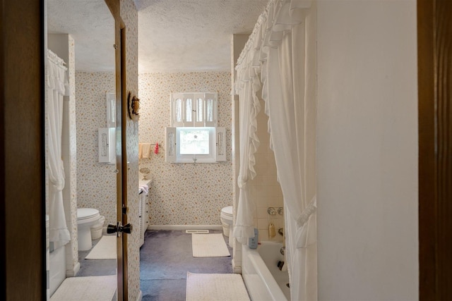 full bathroom featuring shower / bath combination with curtain, vanity, toilet, and a textured ceiling