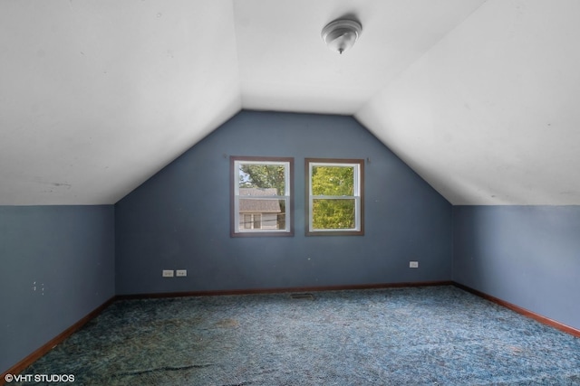 additional living space featuring carpet flooring and lofted ceiling