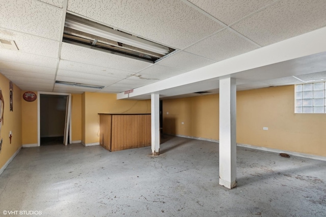 basement featuring a drop ceiling