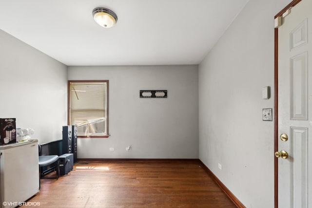 home office with dark wood-type flooring