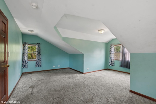 bonus room featuring carpet flooring, lofted ceiling, and a wealth of natural light