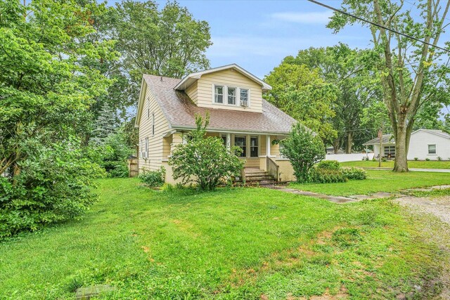 view of front of home featuring covered porch and a front lawn