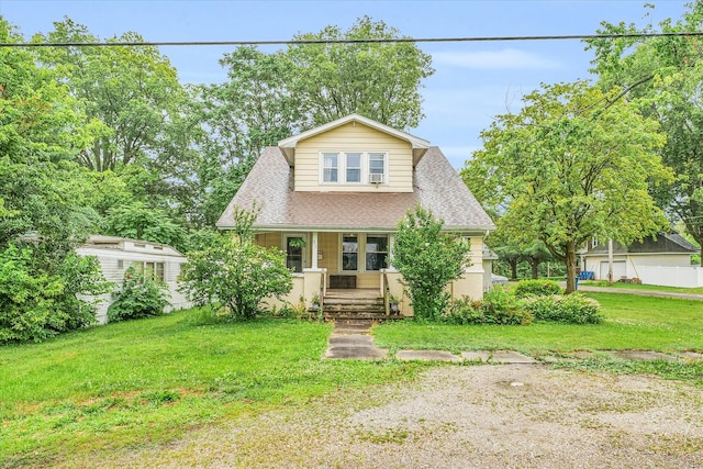 view of front of property featuring a porch and a front lawn