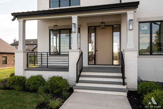 view of exterior entry with covered porch