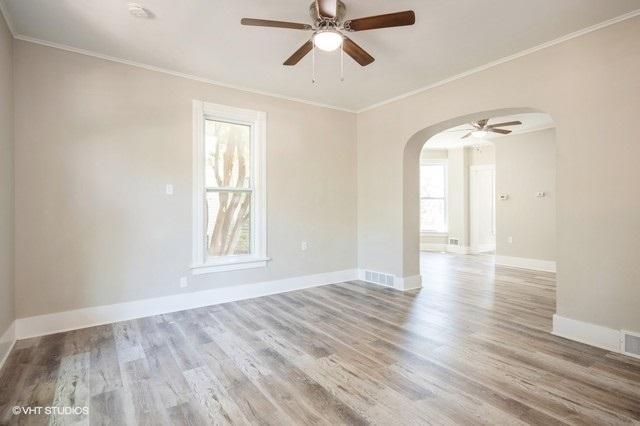 unfurnished room with hardwood / wood-style flooring, ceiling fan, and crown molding