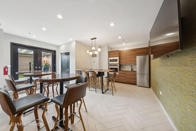 dining room with french doors and light parquet floors