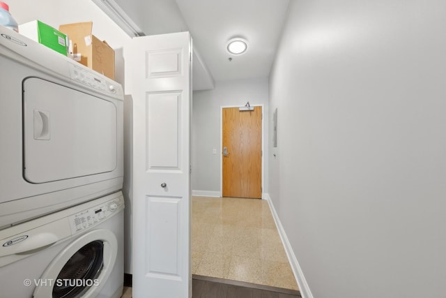 laundry room with stacked washing maching and dryer