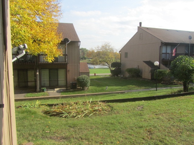 view of yard featuring a balcony and cooling unit