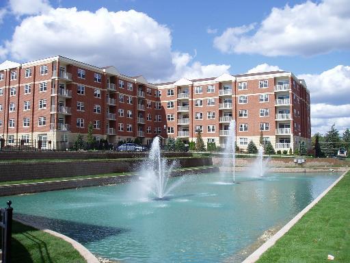 exterior space featuring pool water feature and a water view