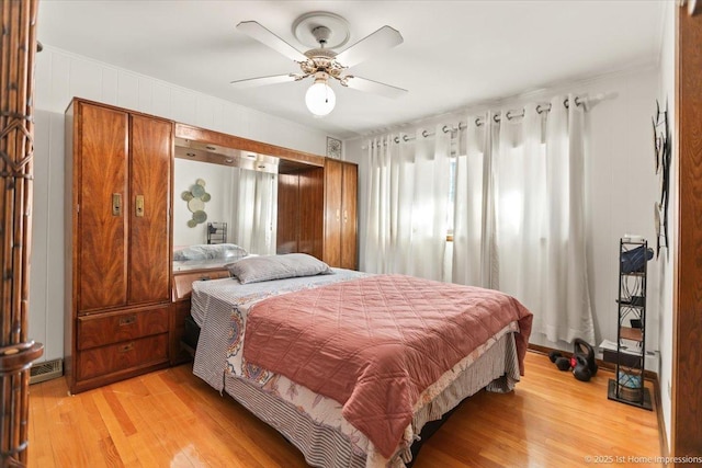 bedroom with ceiling fan and light hardwood / wood-style floors