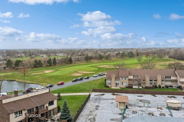 birds eye view of property featuring golf course view and a water view