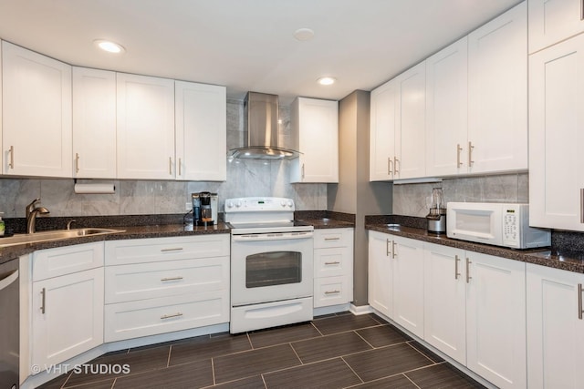 kitchen with white appliances, white cabinets, backsplash, and wall chimney exhaust hood