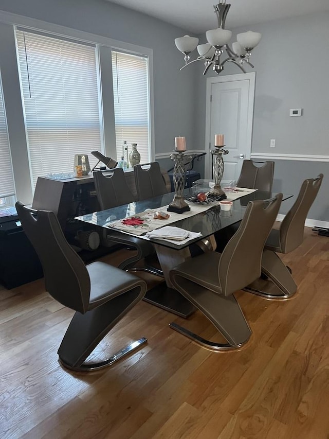 dining room with an inviting chandelier and light hardwood / wood-style flooring