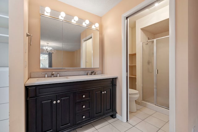 bathroom featuring vanity, toilet, a shower with shower door, and a textured ceiling