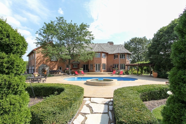 outdoor pool with a patio and a pergola