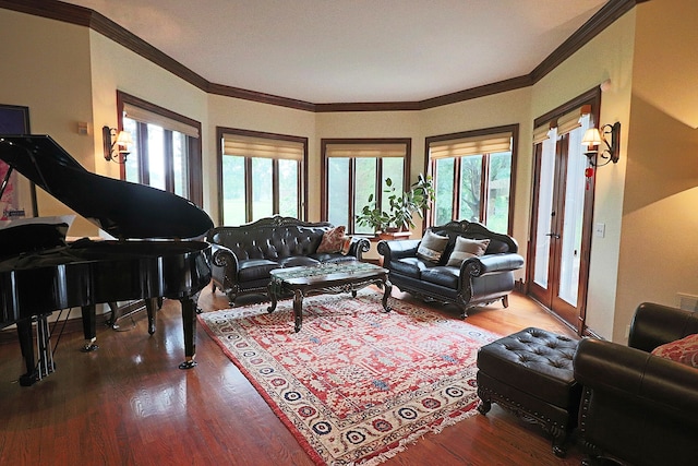 living room with hardwood / wood-style flooring, plenty of natural light, and crown molding