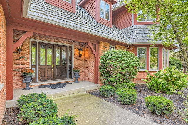 property entrance with french doors and brick siding