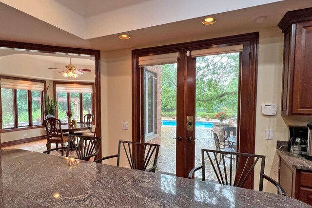 dining area featuring ceiling fan and french doors