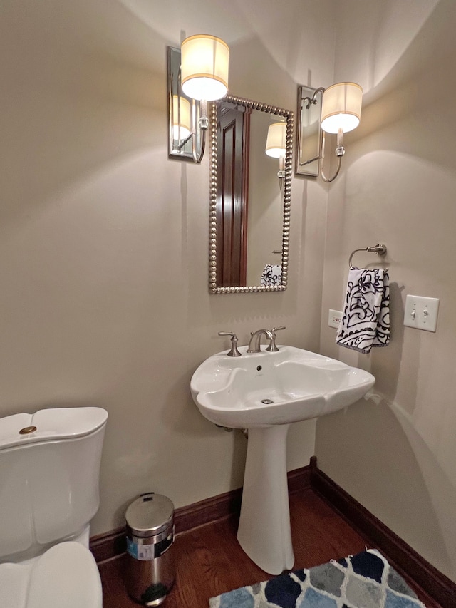 bathroom featuring hardwood / wood-style flooring and toilet