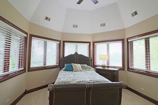 bedroom with ceiling fan, light colored carpet, and vaulted ceiling