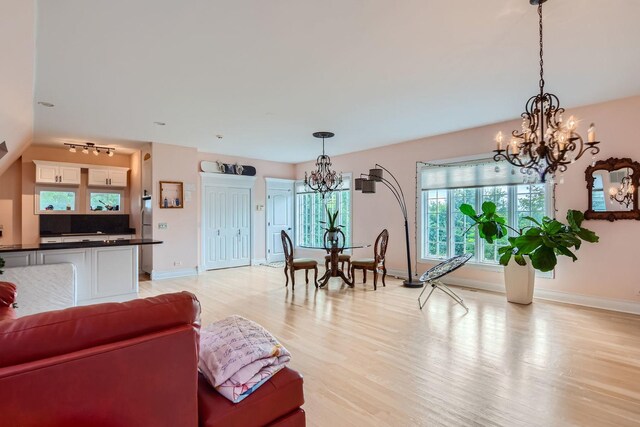 living room featuring light hardwood / wood-style floors and an inviting chandelier