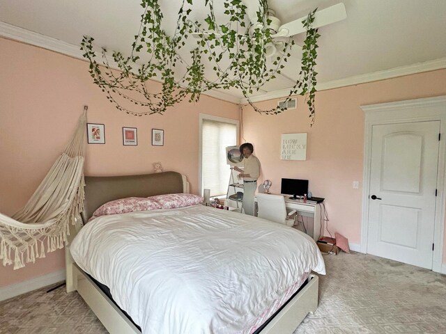 carpeted bedroom with ornamental molding