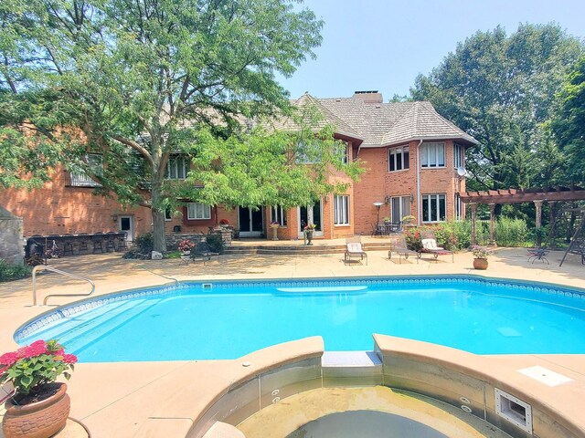 view of pool featuring a pergola and a patio