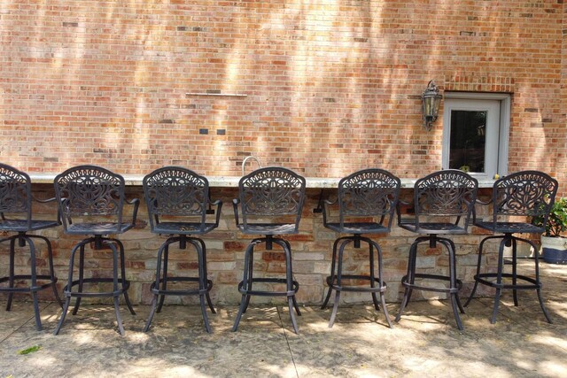 exterior space with bar and brick wall