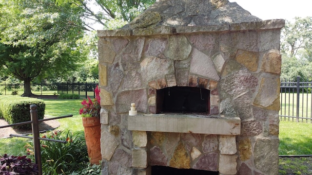 exterior space with an outdoor stone fireplace