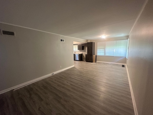 unfurnished living room featuring crown molding and hardwood / wood-style floors