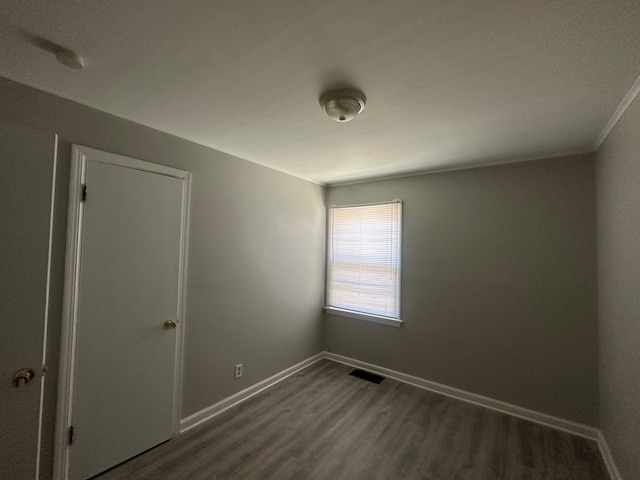 spare room with dark hardwood / wood-style flooring