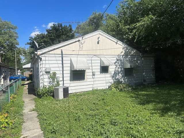 view of outdoor structure with a yard and central AC