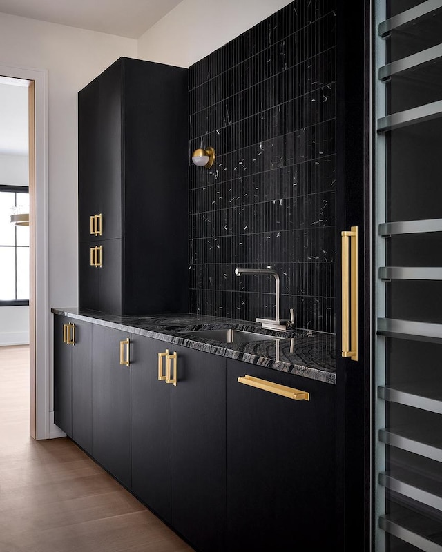 bar with sink and hardwood / wood-style floors