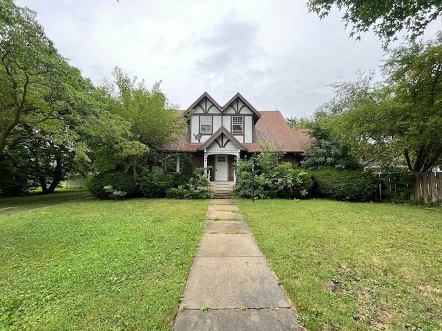 tudor home with a front lawn