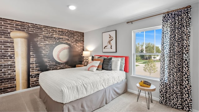 carpeted bedroom featuring brick wall