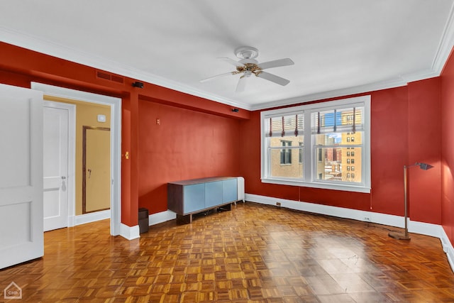 empty room with ceiling fan, parquet floors, and crown molding