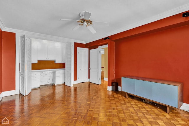 interior space with ceiling fan, crown molding, and light parquet flooring