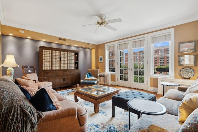 living room with ceiling fan, french doors, light wood-type flooring, and crown molding