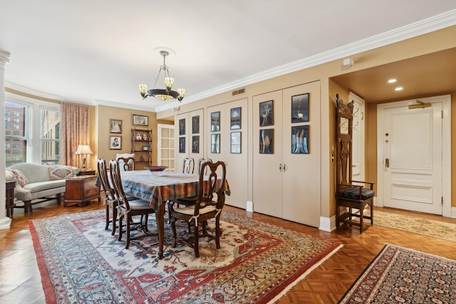 dining room featuring crown molding, parquet floors, and an inviting chandelier