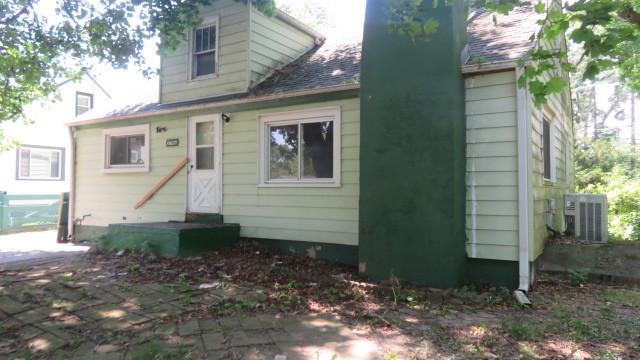 rear view of house featuring cooling unit