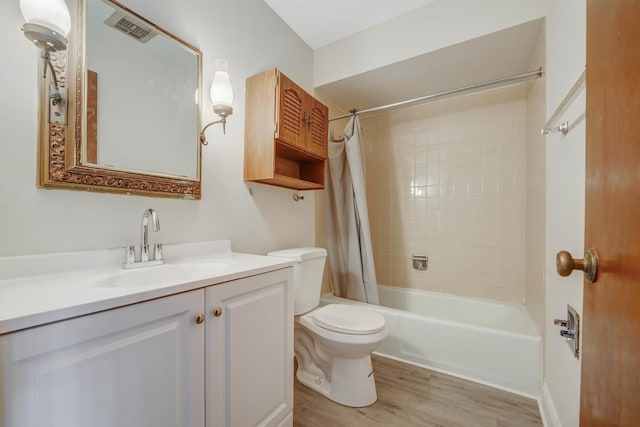 full bathroom featuring toilet, shower / bath combo with shower curtain, vanity, and hardwood / wood-style flooring