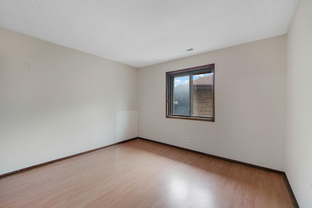 empty room with light hardwood / wood-style floors