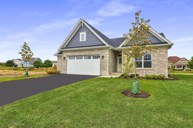 view of front of property with aphalt driveway, a garage, brick siding, and a front lawn