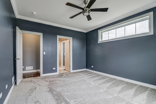 unfurnished bedroom featuring visible vents, carpet floors, crown molding, baseboards, and ceiling fan