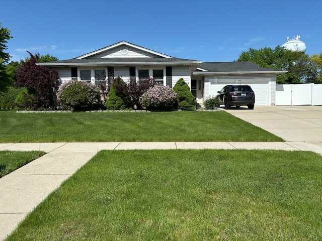 single story home featuring a garage and a front lawn