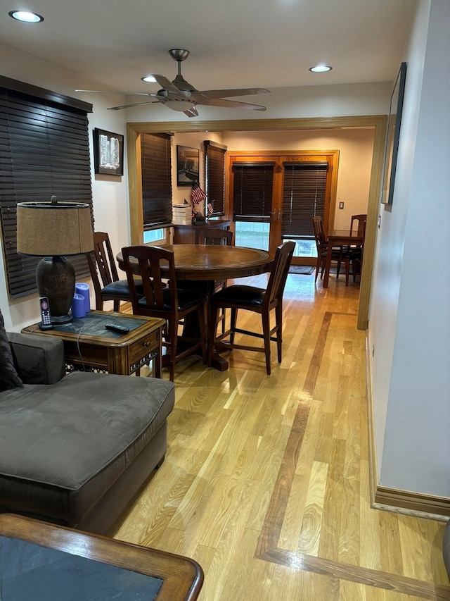 dining space with ceiling fan and light hardwood / wood-style floors