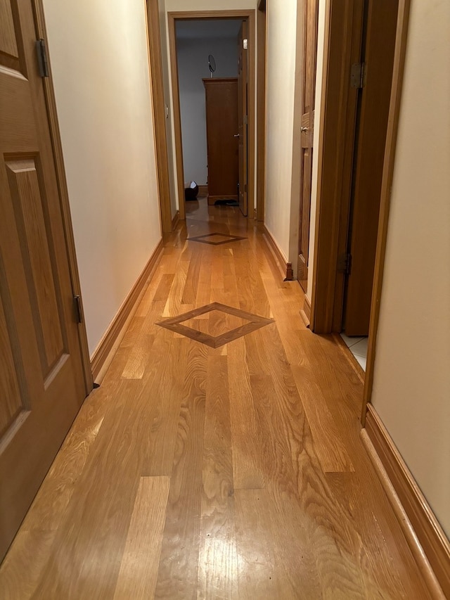 corridor with light hardwood / wood-style flooring