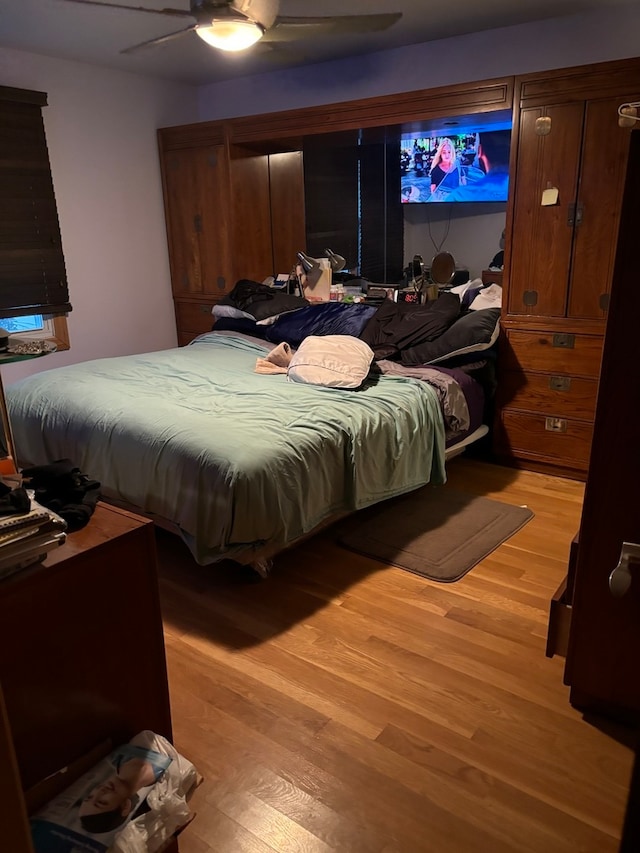 bedroom with ceiling fan and light hardwood / wood-style floors