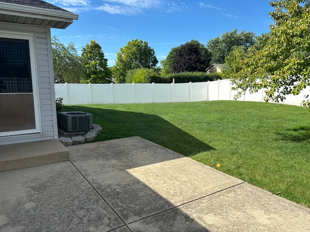 view of yard with central AC and a patio area