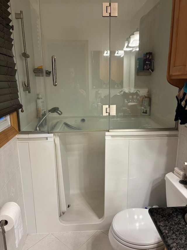 bathroom with toilet and tile patterned floors